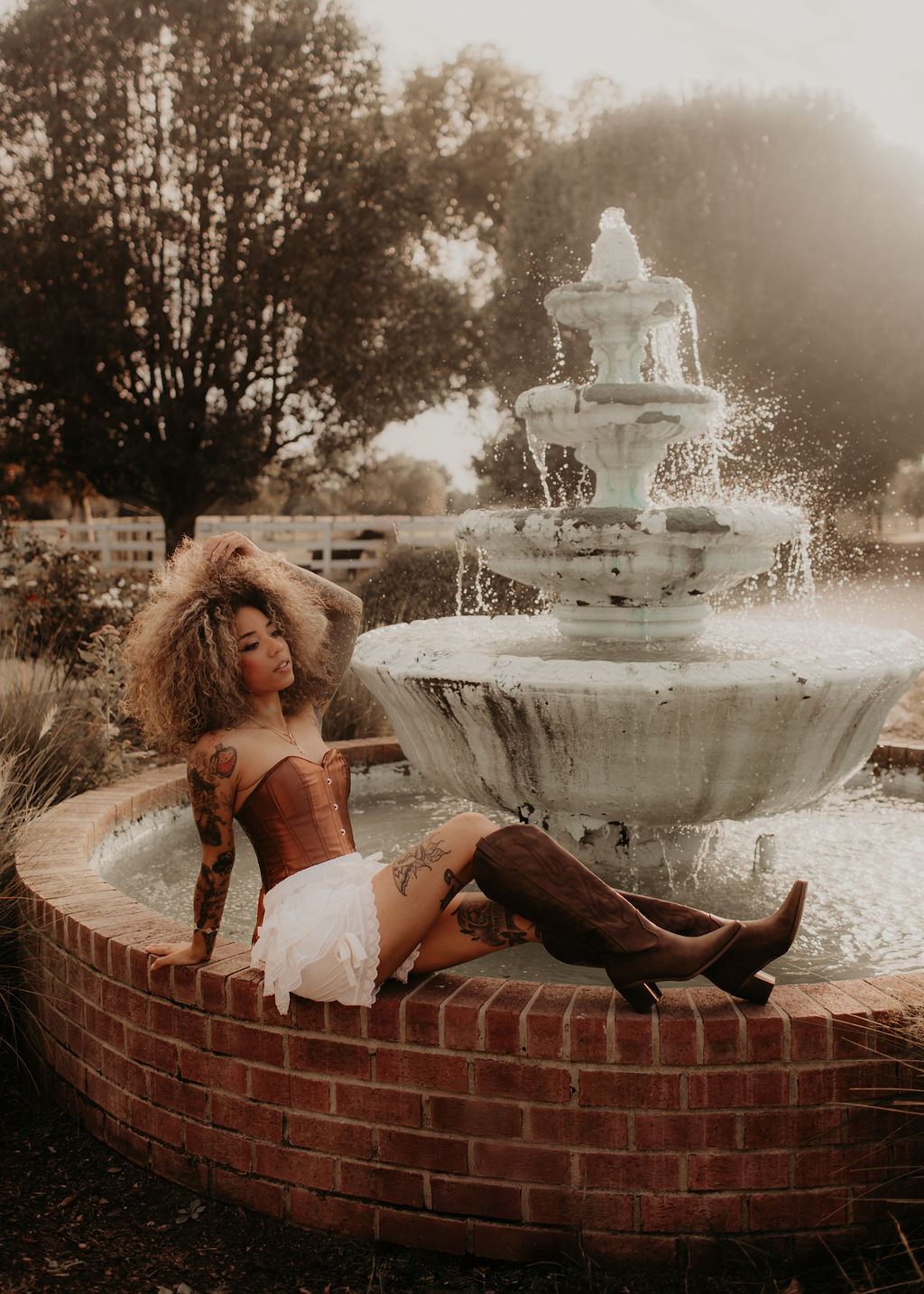 Styled model portrait seated at the fountain at Parkton Place