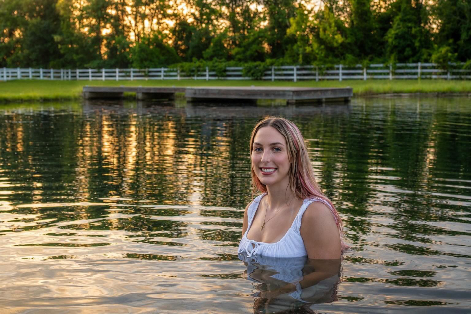 Model smiling in the Parkton Place pond at golden hour
