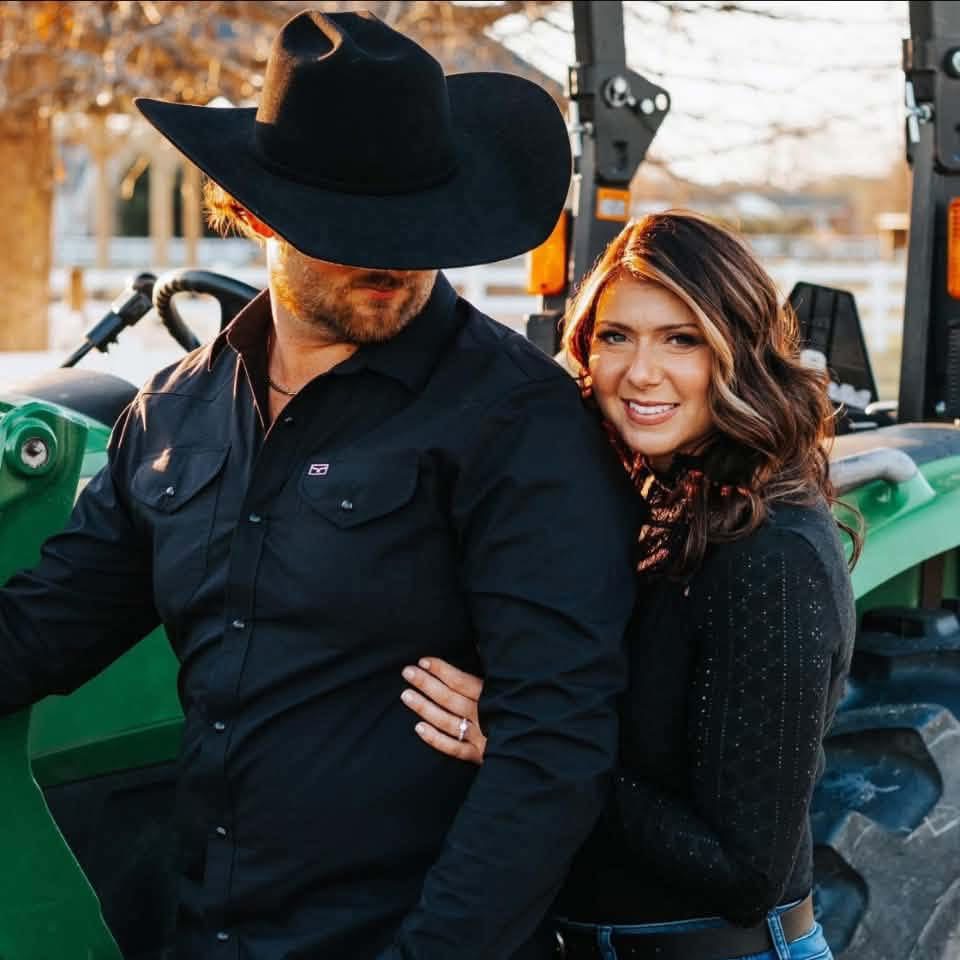 Couples photo shoot on a green farm tractor at Parkton Place near Fayetteville, NC